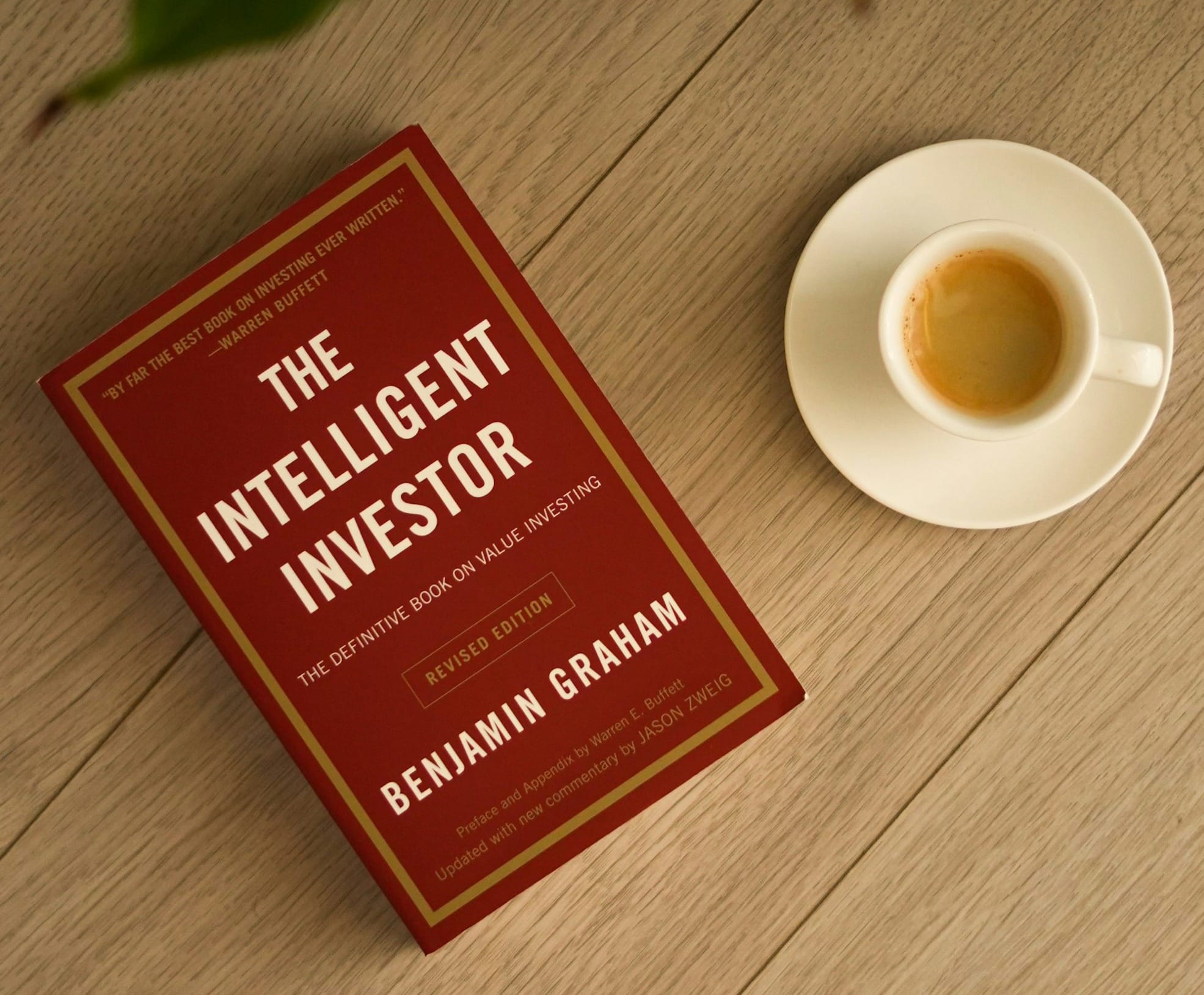 The intelligent investor book with a cup of espresso.